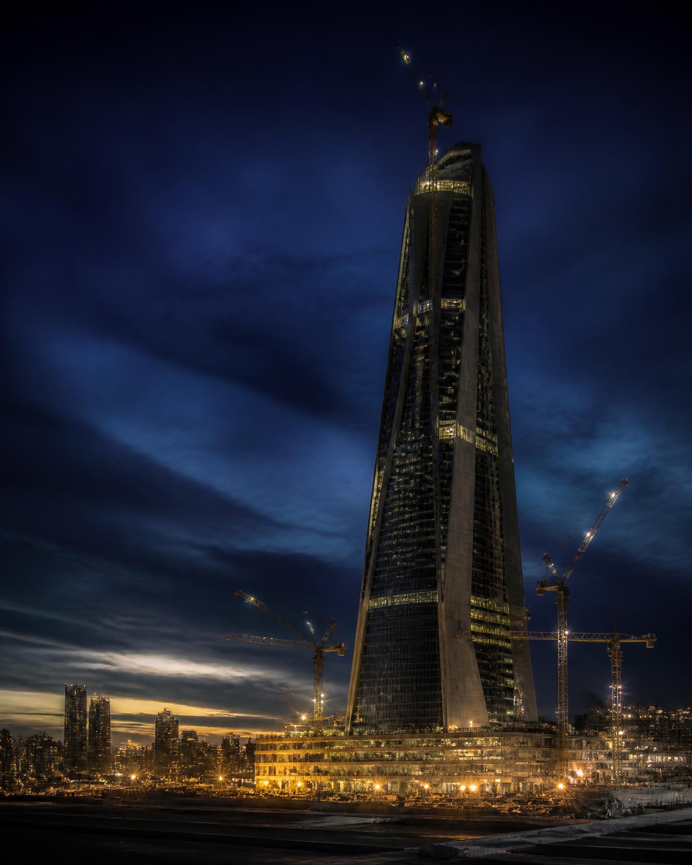 Modern tower under construction at blue hour